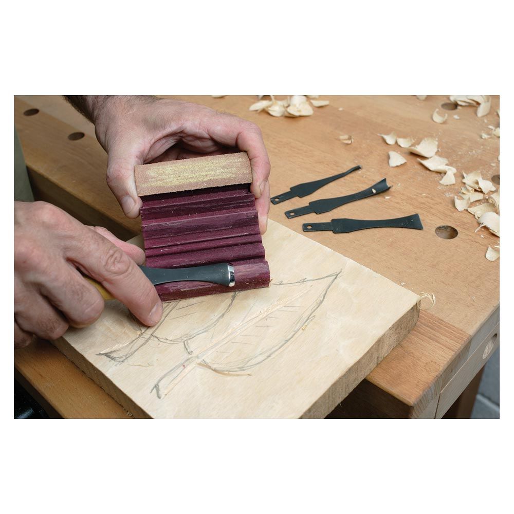 Flexcut slipstrop shown with carver sharpening a gouge blade.