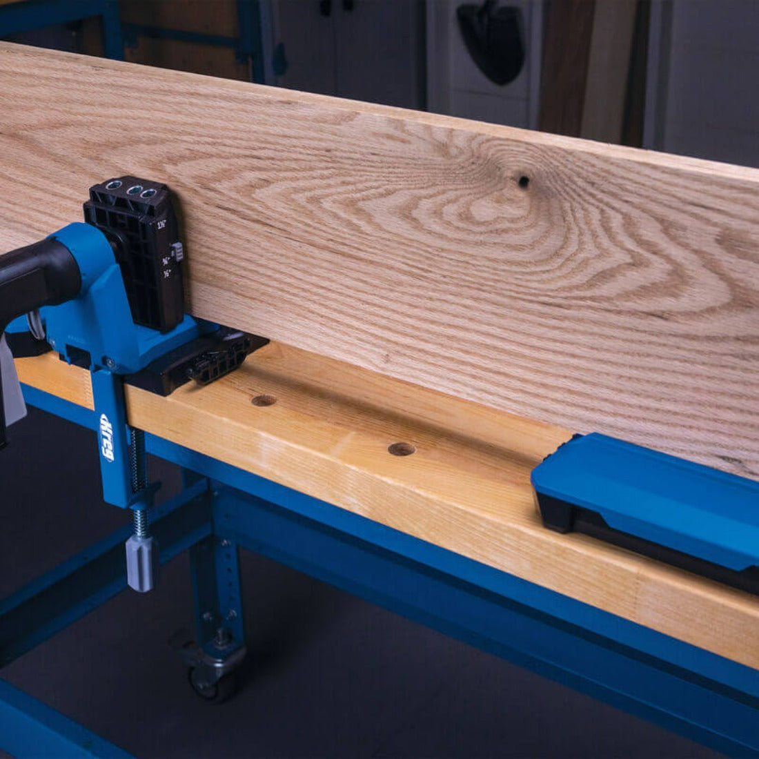 image shows long plank drilled with 520 jig and docking station supports holding up the plank to keep level