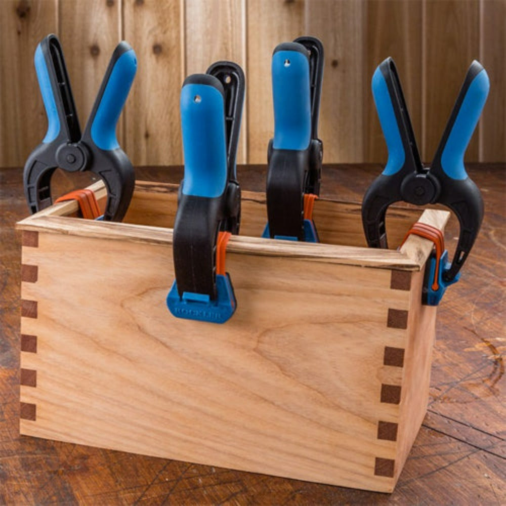 Rockler Bandy Clamps shown clamping a border edge onto a wooden box