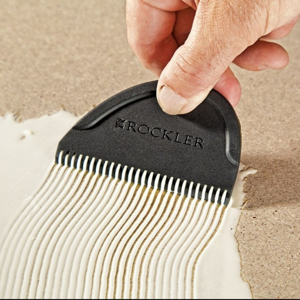 image shows user spreader with water based white glue showing the combed effect on a flat board